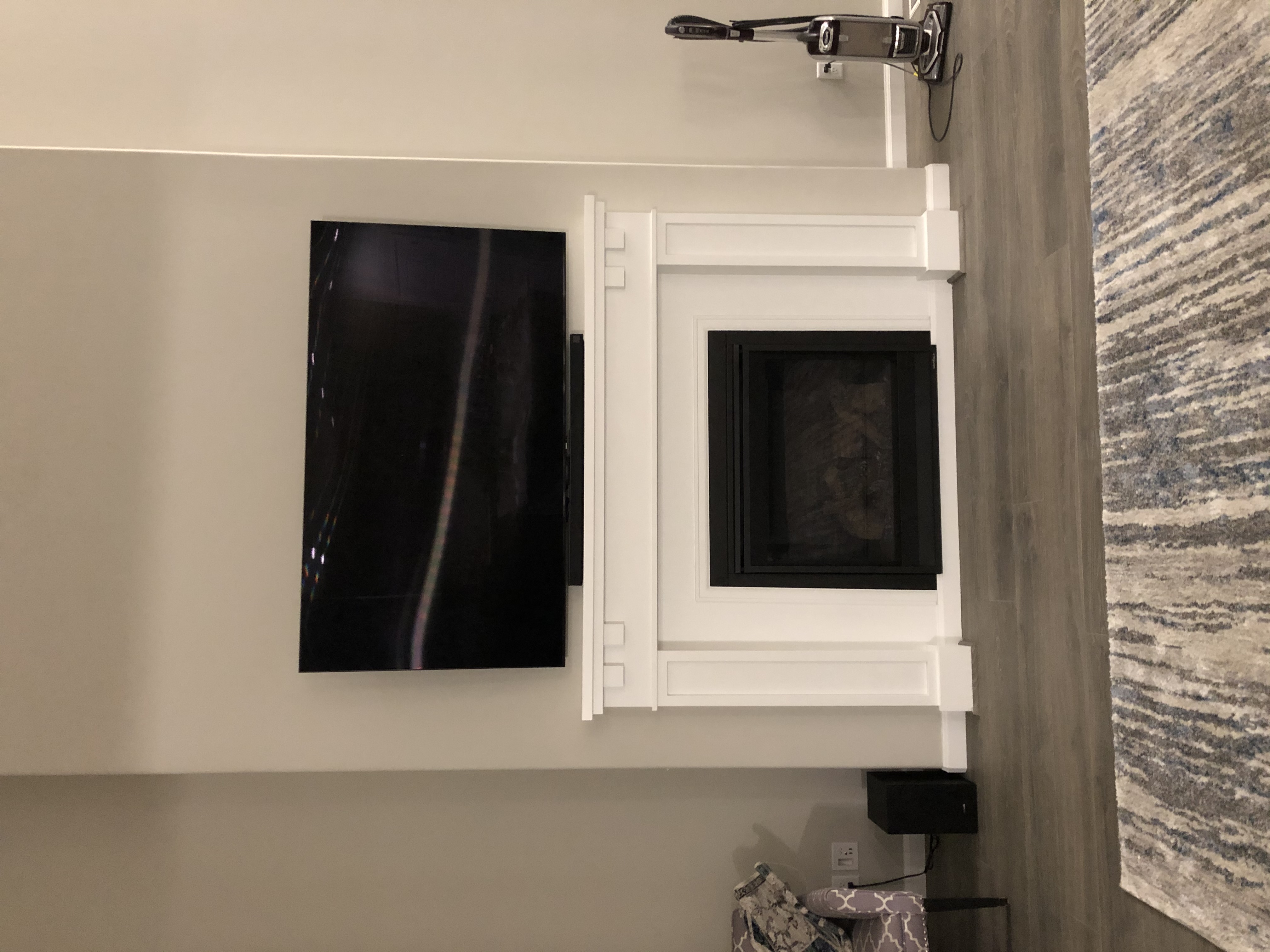TV mounted above fireplace, cables fully hidden
