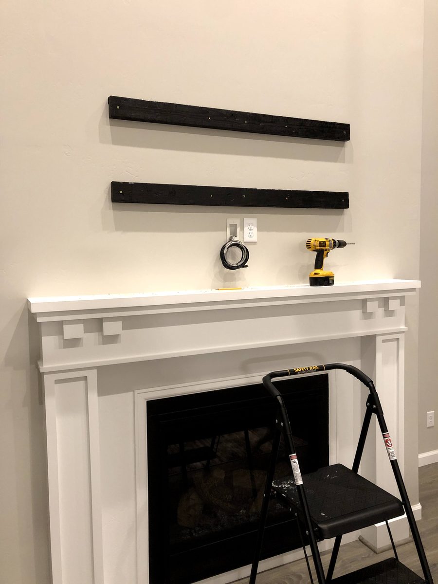 Wall prep for TV mount — backing boards and cable routing in progress